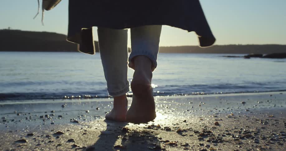 A person walking into water
