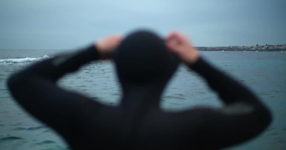 A man is getting ready to swim in the ocean
