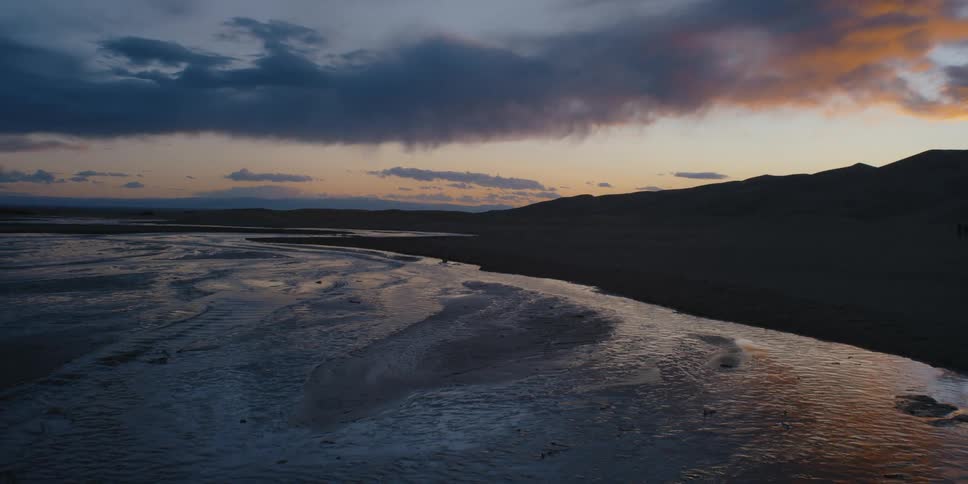 River flowing through sand dunes