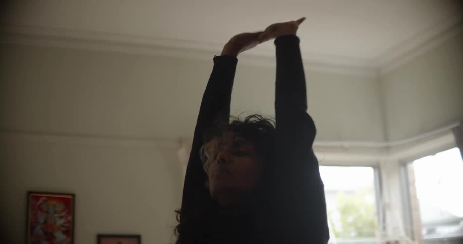 A woman stretching in a room