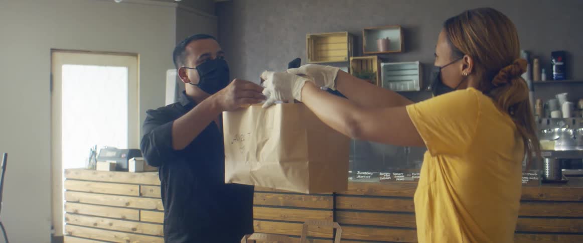 Store owner delivers an order to a client inside the store