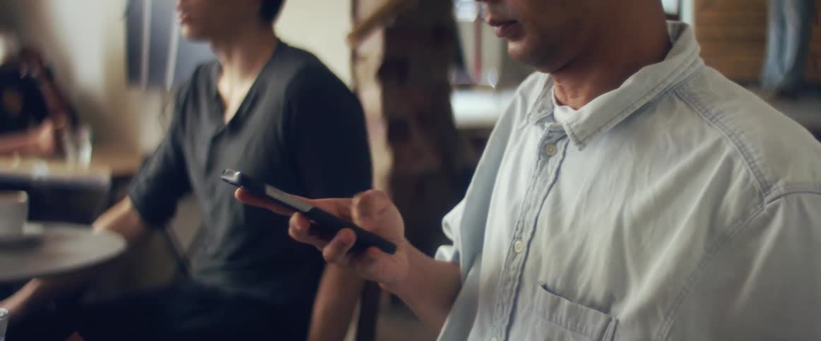A man using a phone in a restaurant