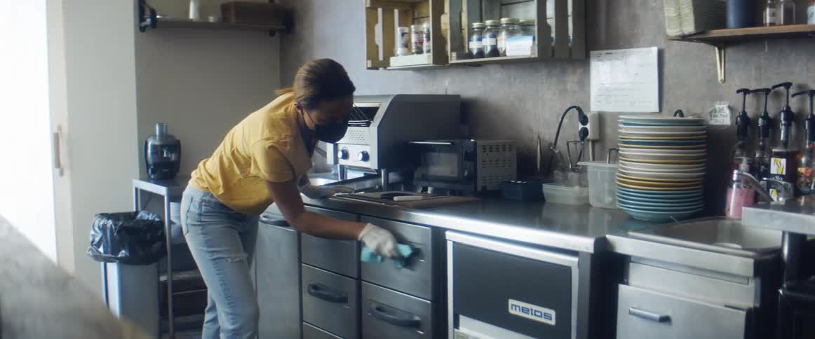 Person cleaning kitchen