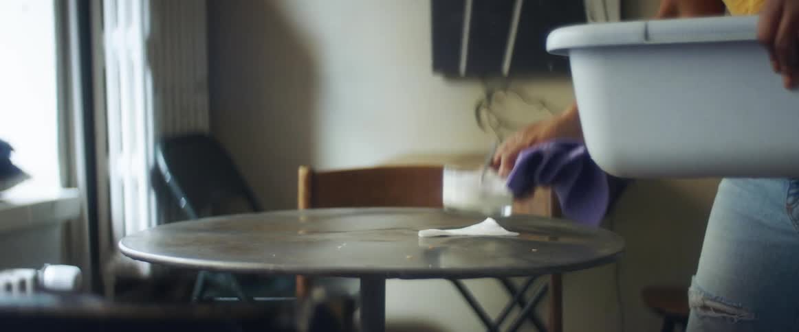 A person cleaning off a table