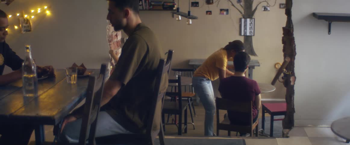 Waitstaff removes coffee cups from customers table