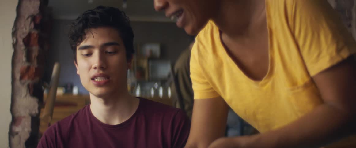 A waitress serves a young man in a restaurant
