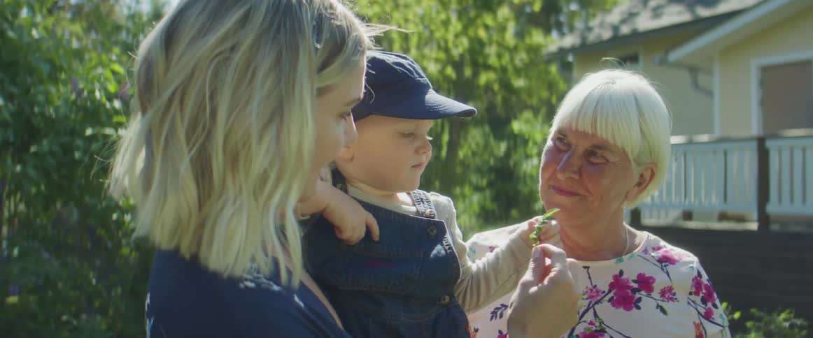 A mother daughter and grandmother standing outdoors