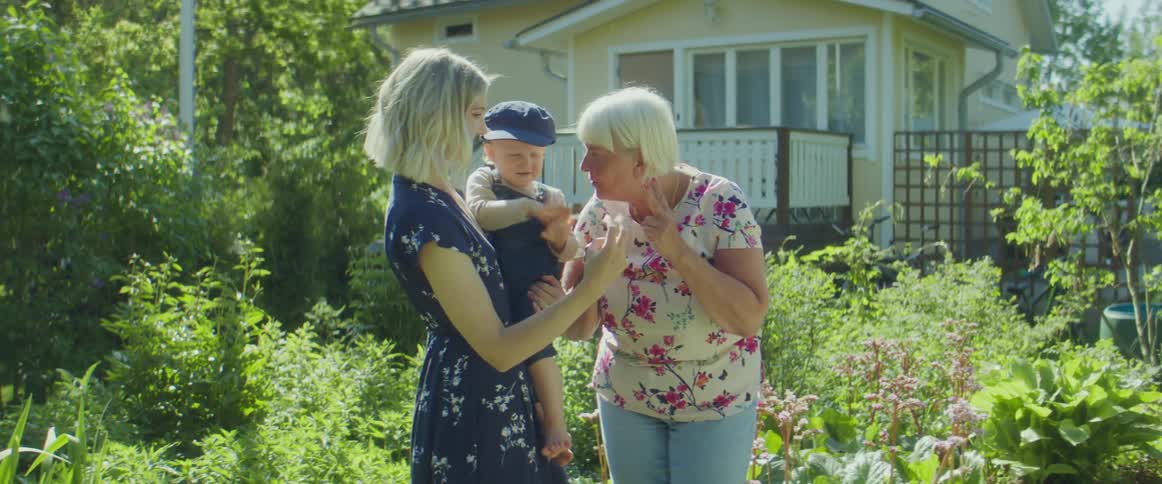 A mother and her daughter talking with a grandmother