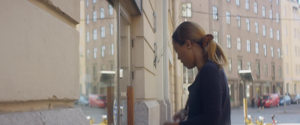 A woman that is walking outdoors on a sidewalk