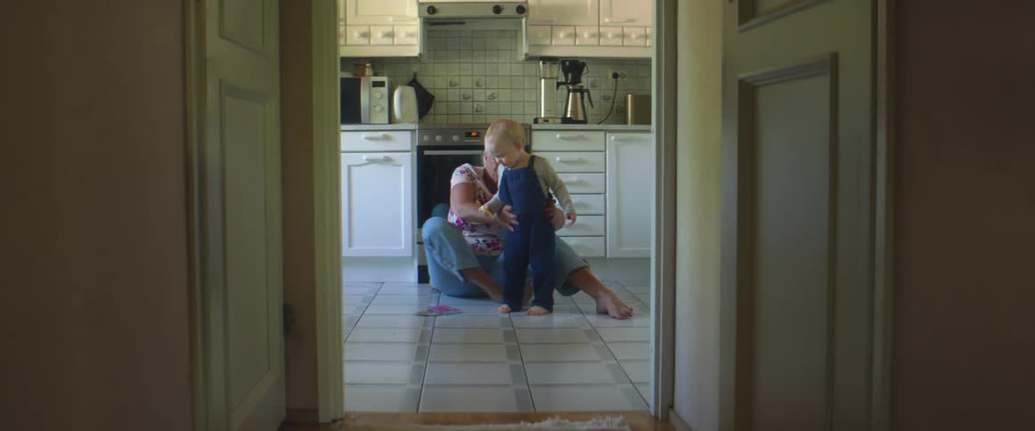 A grandmother and granddaughter playing on the floor in a room