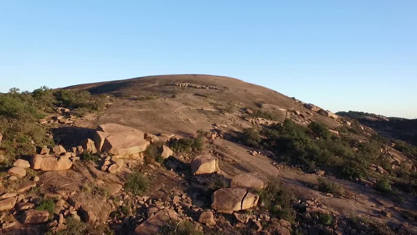 A rocky hill under a cloudless sky