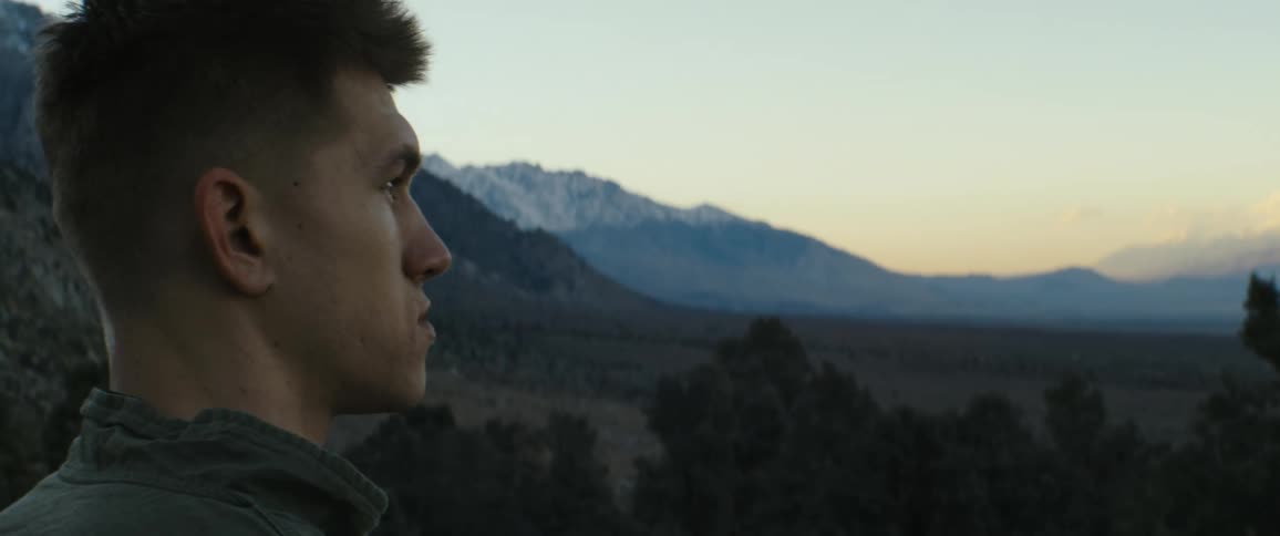 A man overlooking mountains at sunset