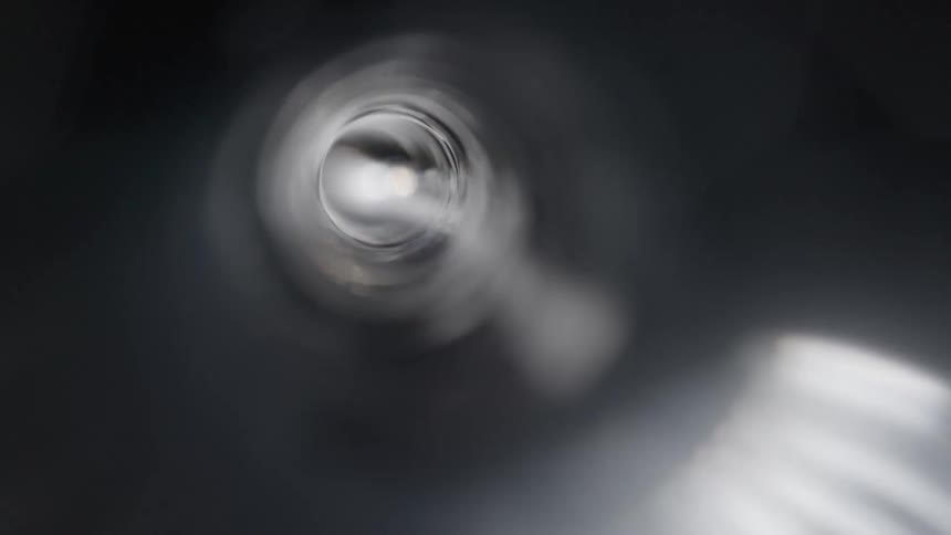 The hole in the center of a spinning liquid grows wider