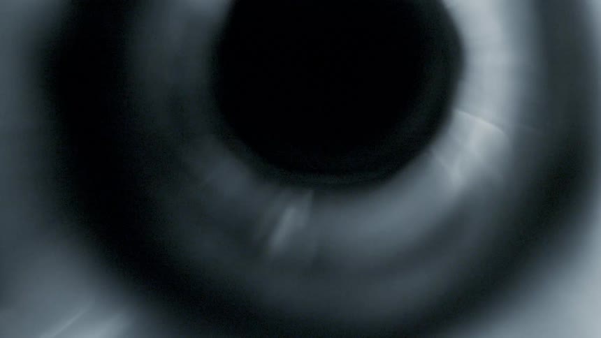 A silver tube spins around rapidly