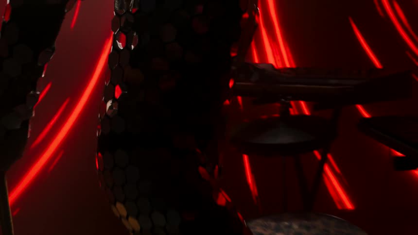 A musician wearing a reflective bodysuit puts on a helmet as he stomps on a drum set pedal with red lights behind him