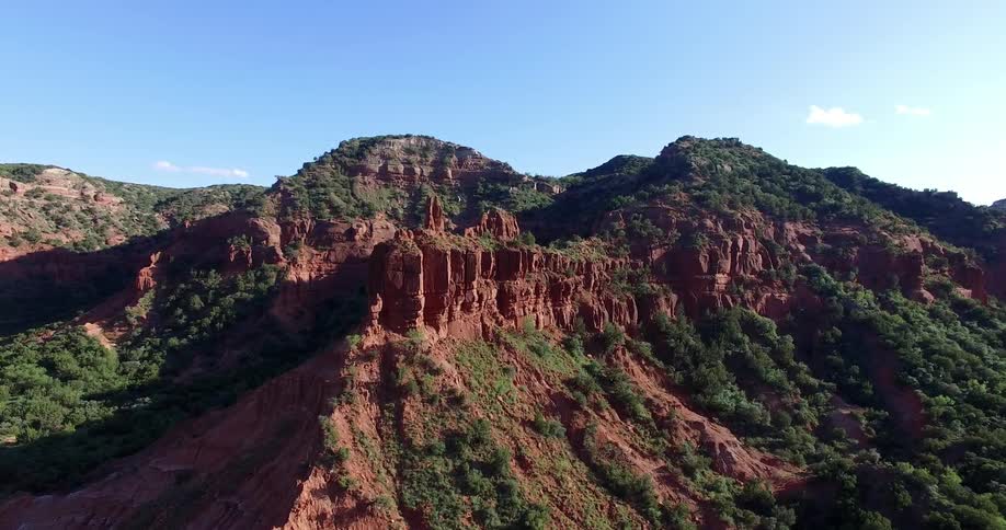 Aerial view of a mountain covered with grass