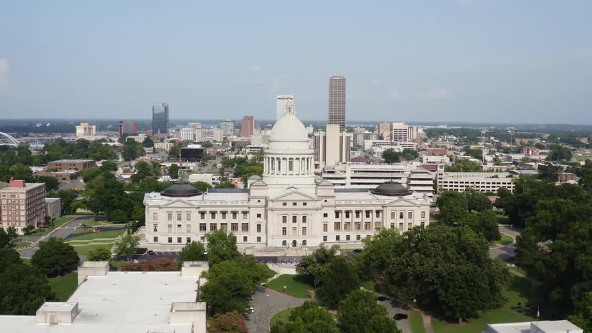 Domed government building sits near city center under cloudy sky