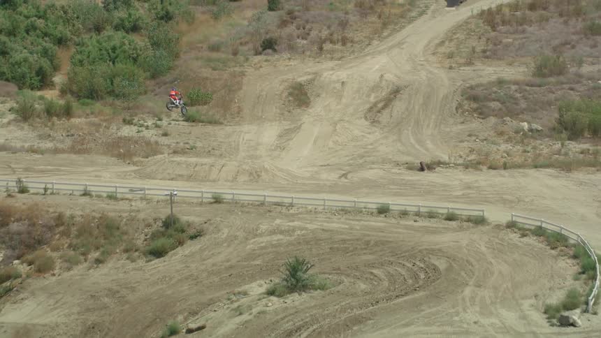 A man that is jumping a dirt bike outdoors