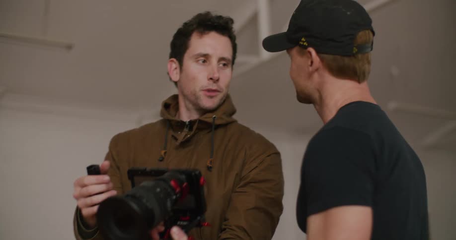 One men is showing camera footage to another man as they discuss about