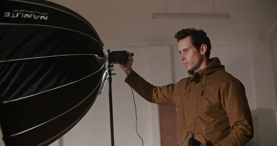 A man setting up spot lights