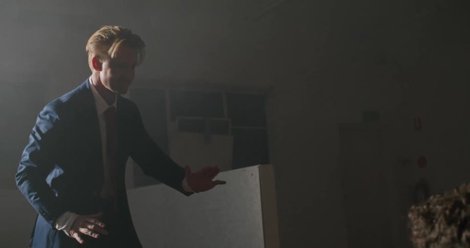 A man performs dance moves as a photographer takes pictures