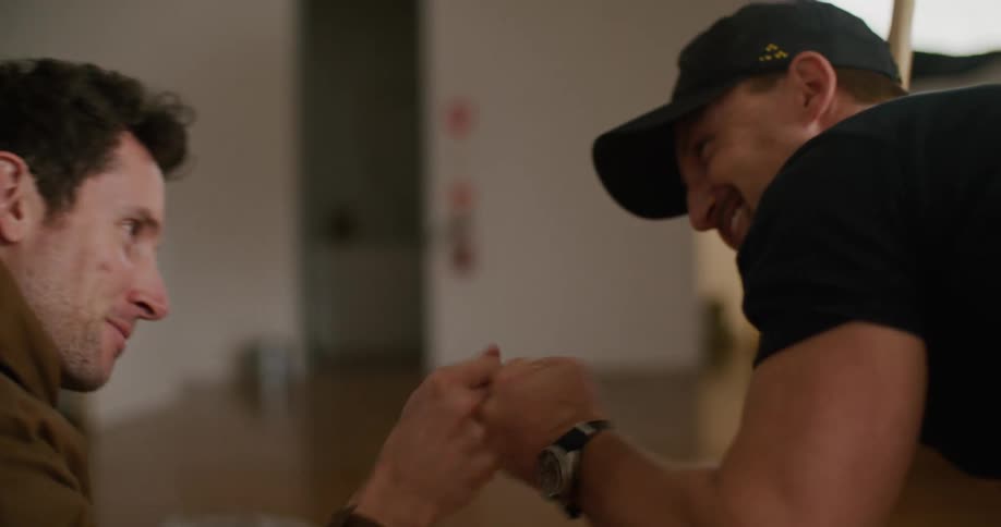 Two happy smiling men fist bump after reviewing the pictures on a camera