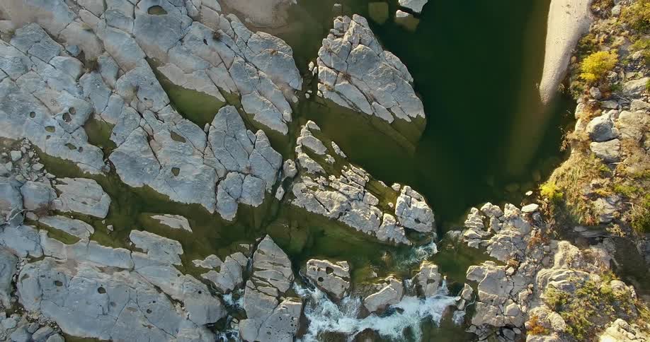 Aerial view of a river flowing through tall rocks