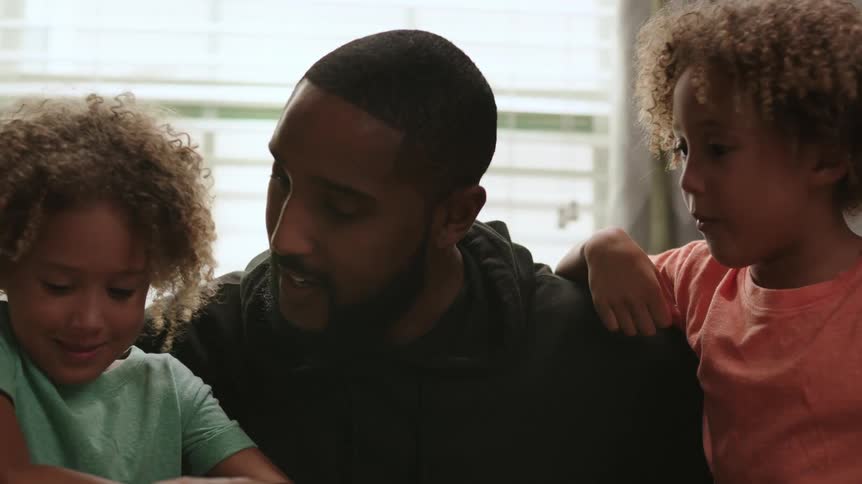 A father talks with his two daughters
