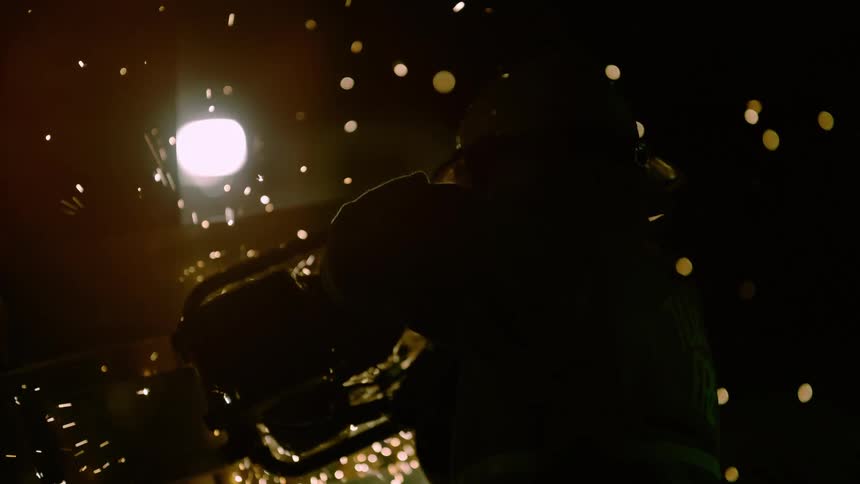 Person welding in dark