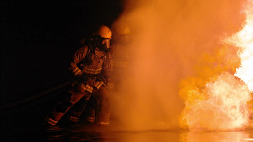 Two firefighters fighting a fire
