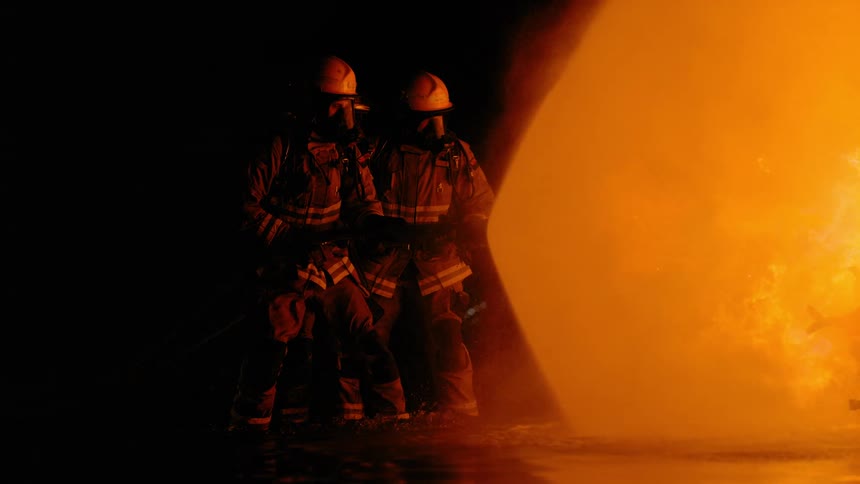 Two firefighters fighting a fire