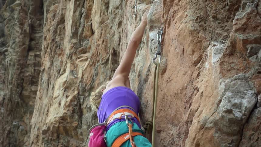 A woman is rock climbing
