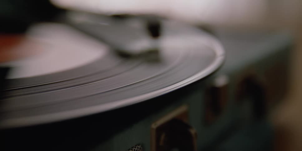 A record spinning on a record player with a needle in a room