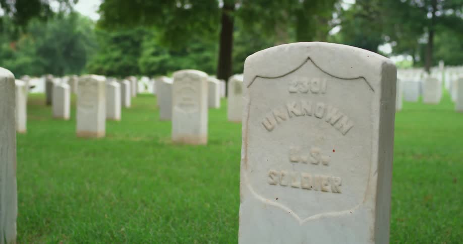 A cemetery is filled with numerous tombstones for deceased unknown soldiers