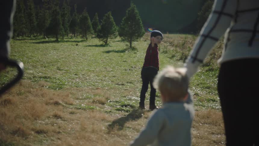 Parents walk with their children on the field