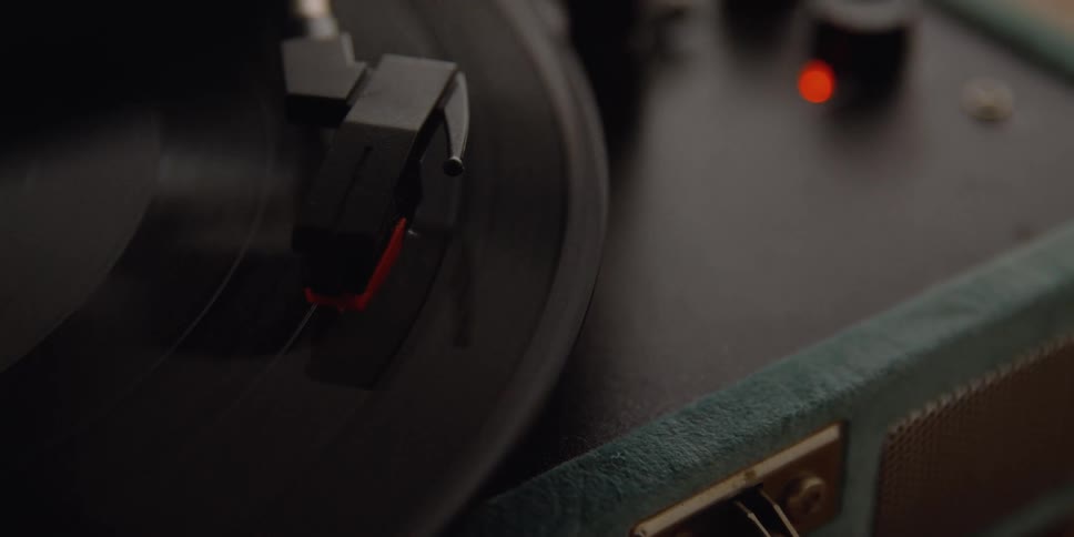 An album plays on a vintage case record player