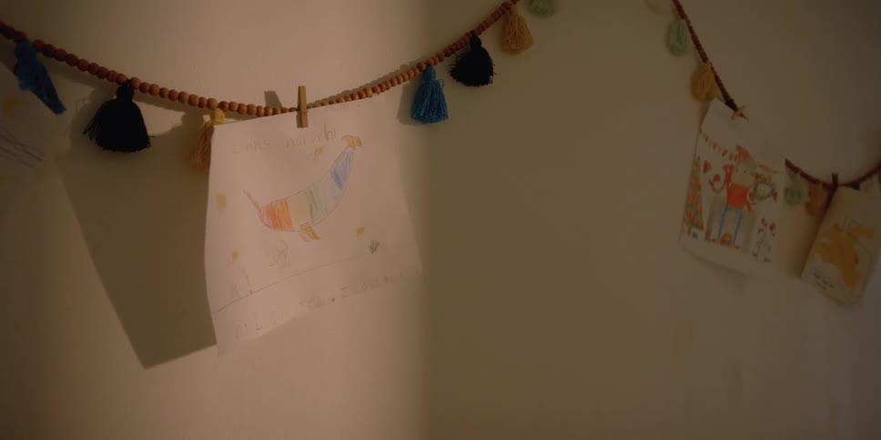 Hand made drawings hanging from the wall at home