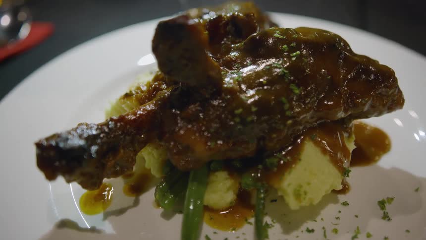 A meal on a dinner plate on a table in a restaurant