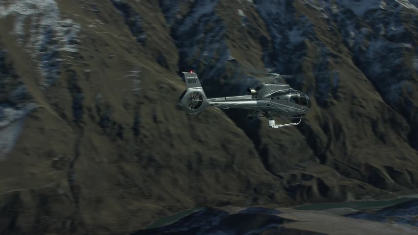 A view of a helicopter flying out in a canyon