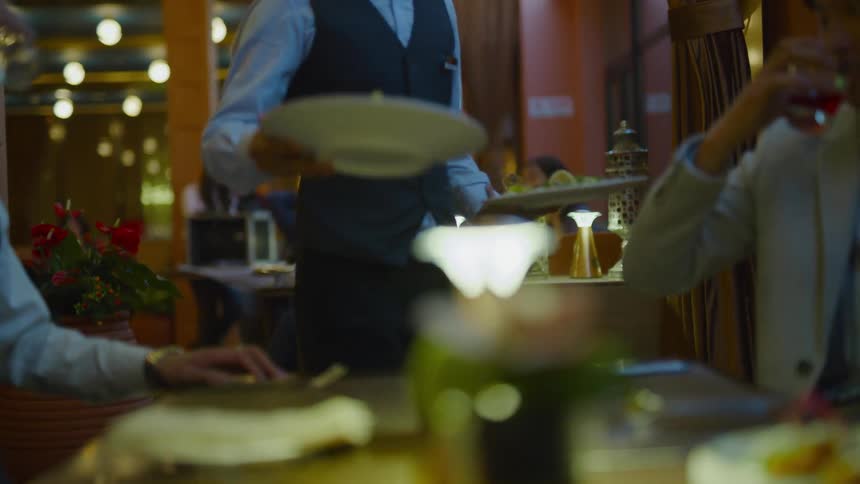 A group of people eating together at a restaurant