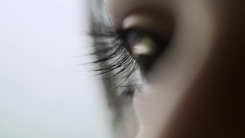 A young womans eye reflecting her surroundings