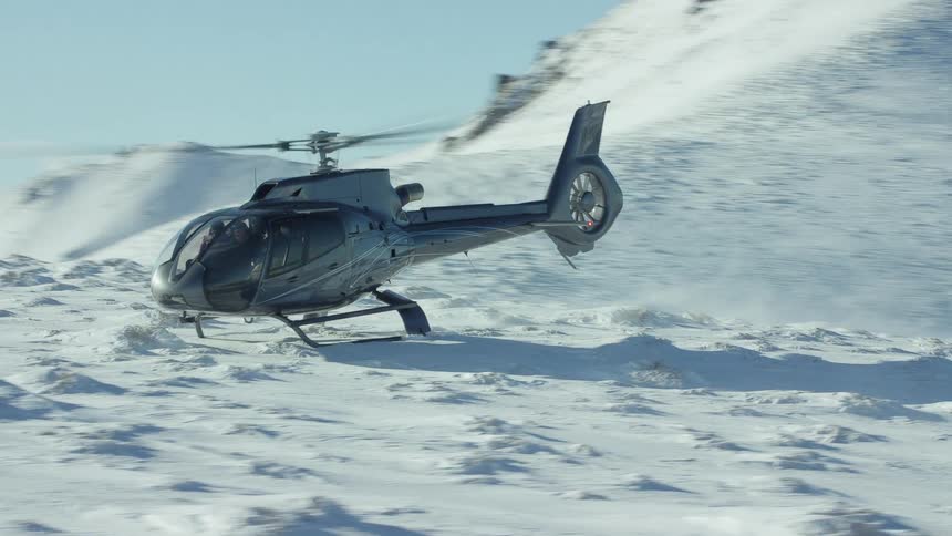 An orbiting shot of a helicopter on a mountain