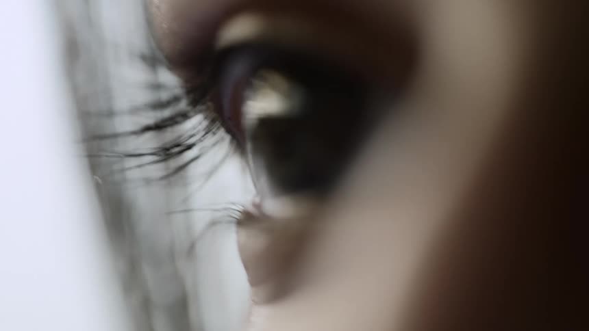 A persons eye in a room with a wall in the background