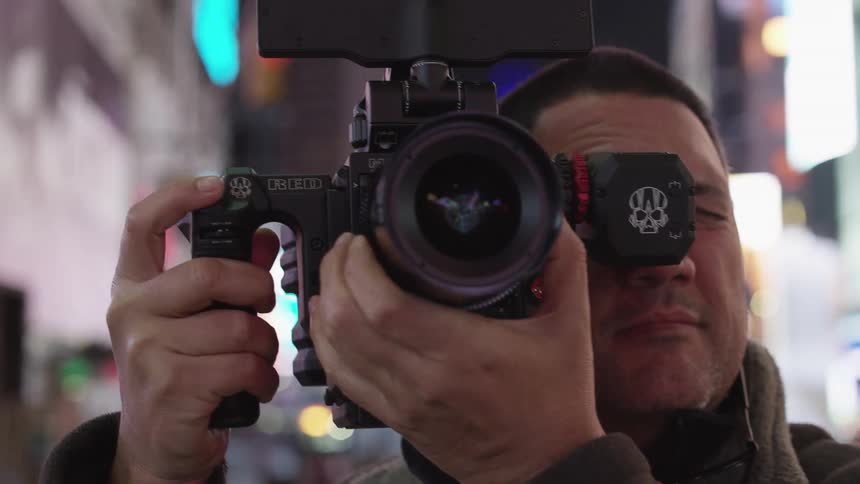 A man using a camera to film