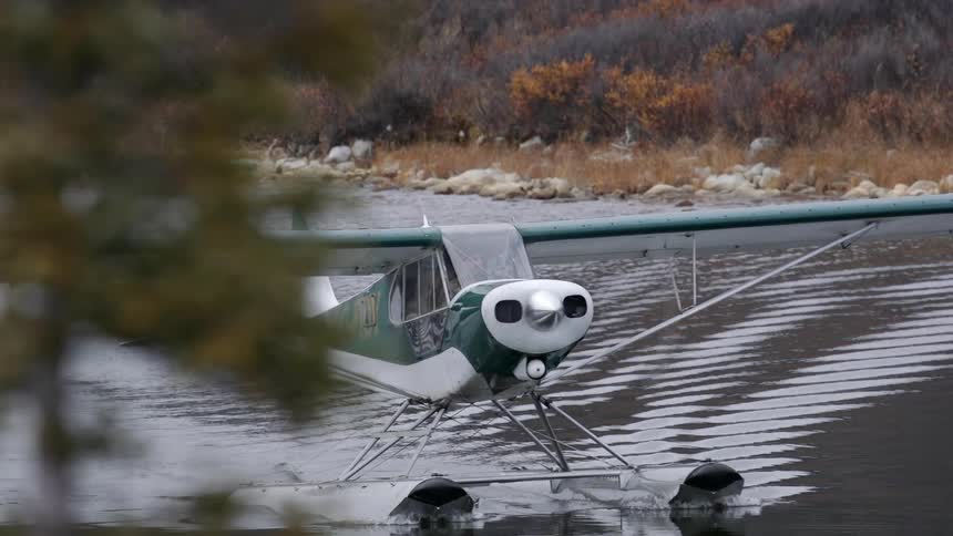 A plane is moving across the water