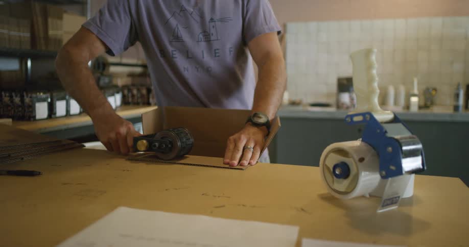 A man handling cardboard boxes at work