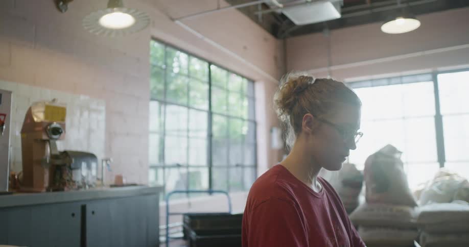 A woman working in a store at a counter
