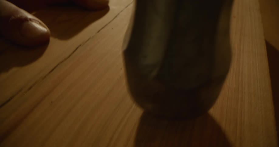 A person hammering a nail into a board