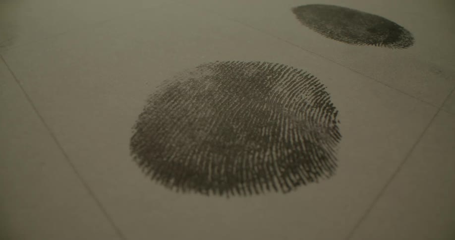 A person putting their fingerprint on a piece of paper