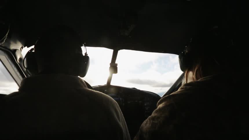Two pilots fly a plane